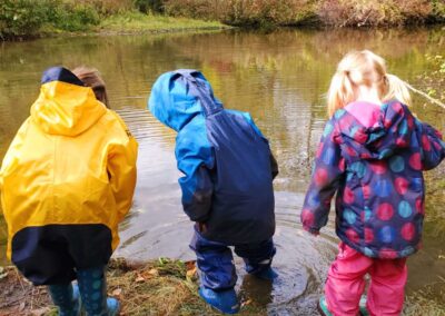 Children by the water's edge at Star Seedlings