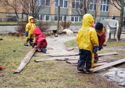 Children playing with boards in the backyard at Star Seedlings