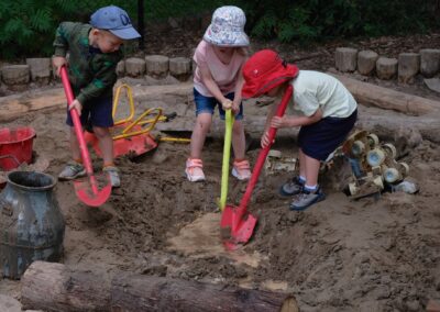 Children digging in the garden at Star Seedlings Family & Childcare Centre